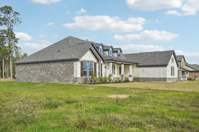 a front view of house with yard and green space