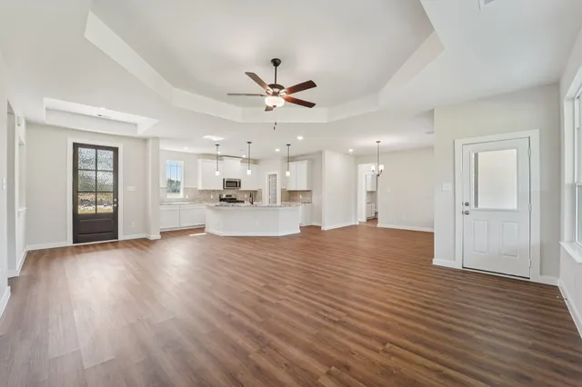 a view of kitchen and hall with wooden floor