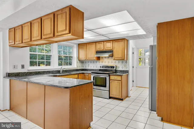 a living room with furniture wooden floor and a large window
