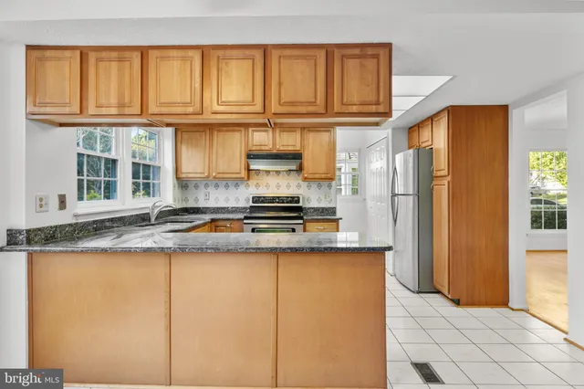 a view of a kitchen with granite countertop cabinets and a sink