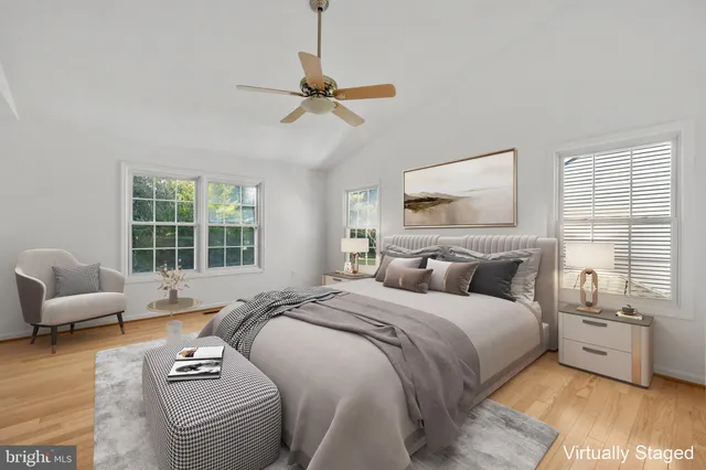 a view of an empty room with chandelier fan