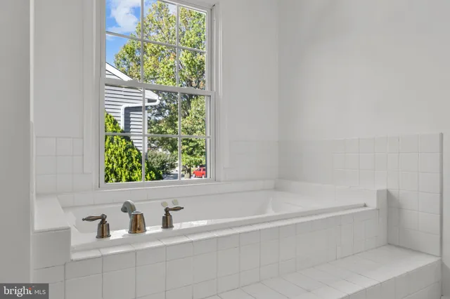 a view of a room with a fan & a chandelier fan