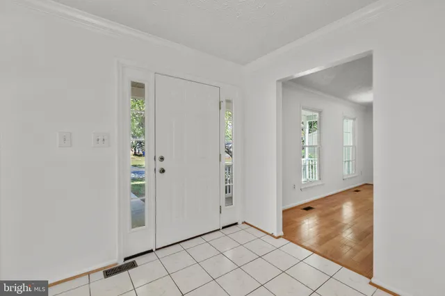 a dining room with furniture a window and wooden floor