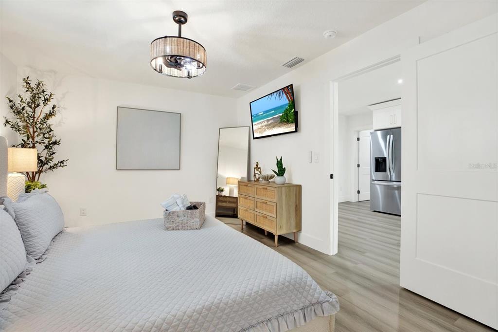 Undisclosed Address Tampa, FL 33607 - Photo 11 of 31 a bedroom with a bed and a chandelier