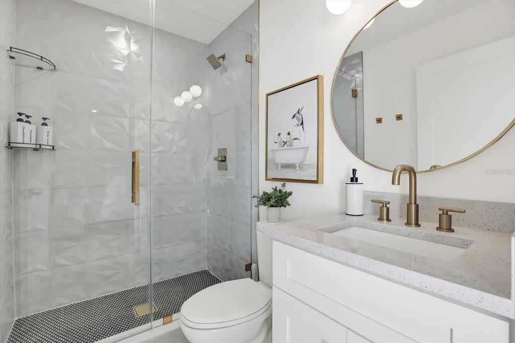 Undisclosed Address Tampa, FL 33607 - Photo 19 of 31 a bathroom with a granite countertop sink a toilet and shower