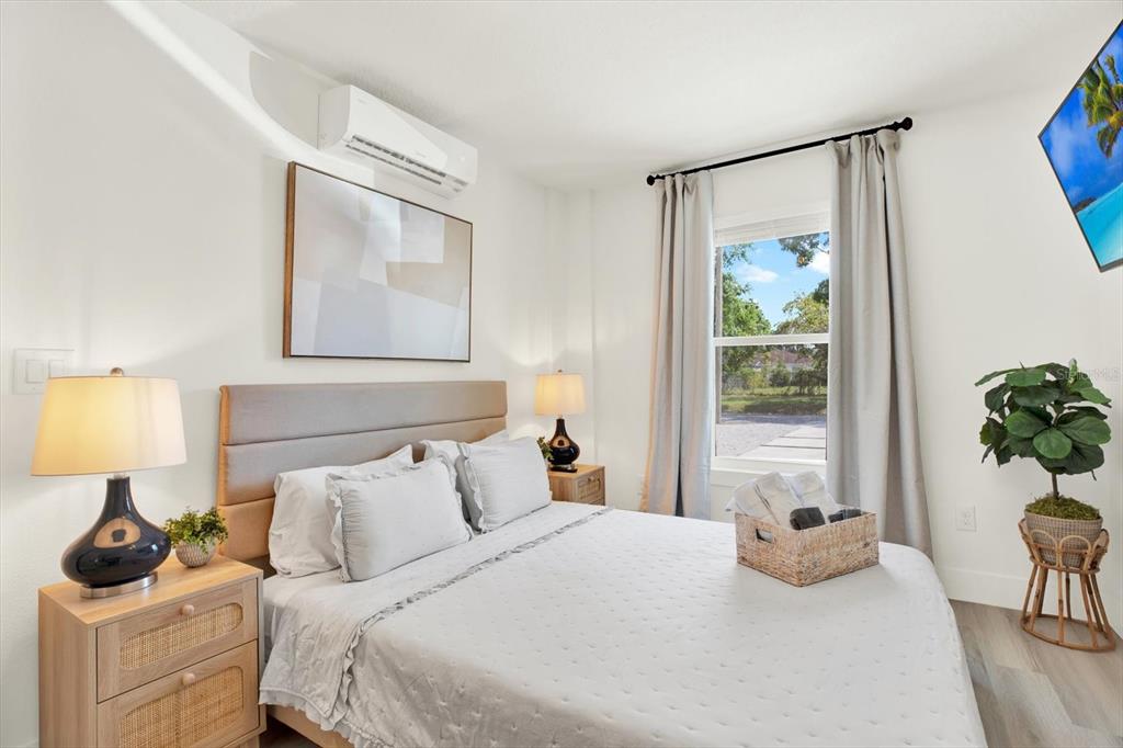 Undisclosed Address Tampa, FL 33607 - Photo 20 of 31 a bedroom with a bed and wooden floor