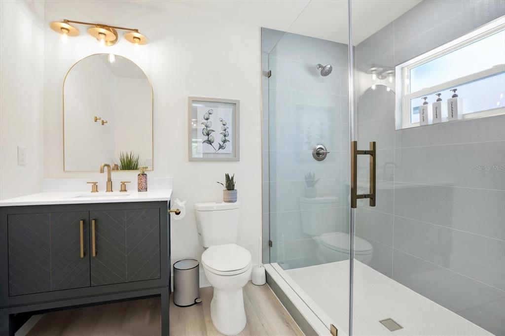 Undisclosed Address Tampa, FL 33607 - Photo 22 of 31 a bathroom with a sink a toilet and shower