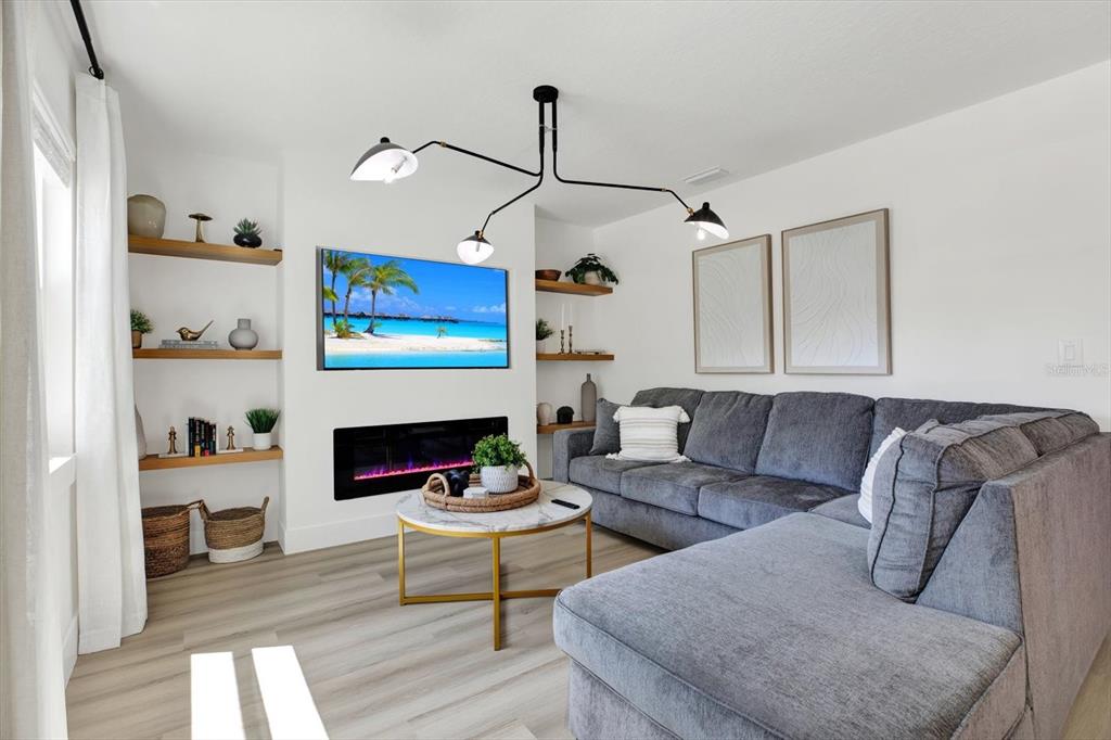 Undisclosed Address Tampa, FL 33607 - Photo 3 of 31 a living room with furniture and a fireplace