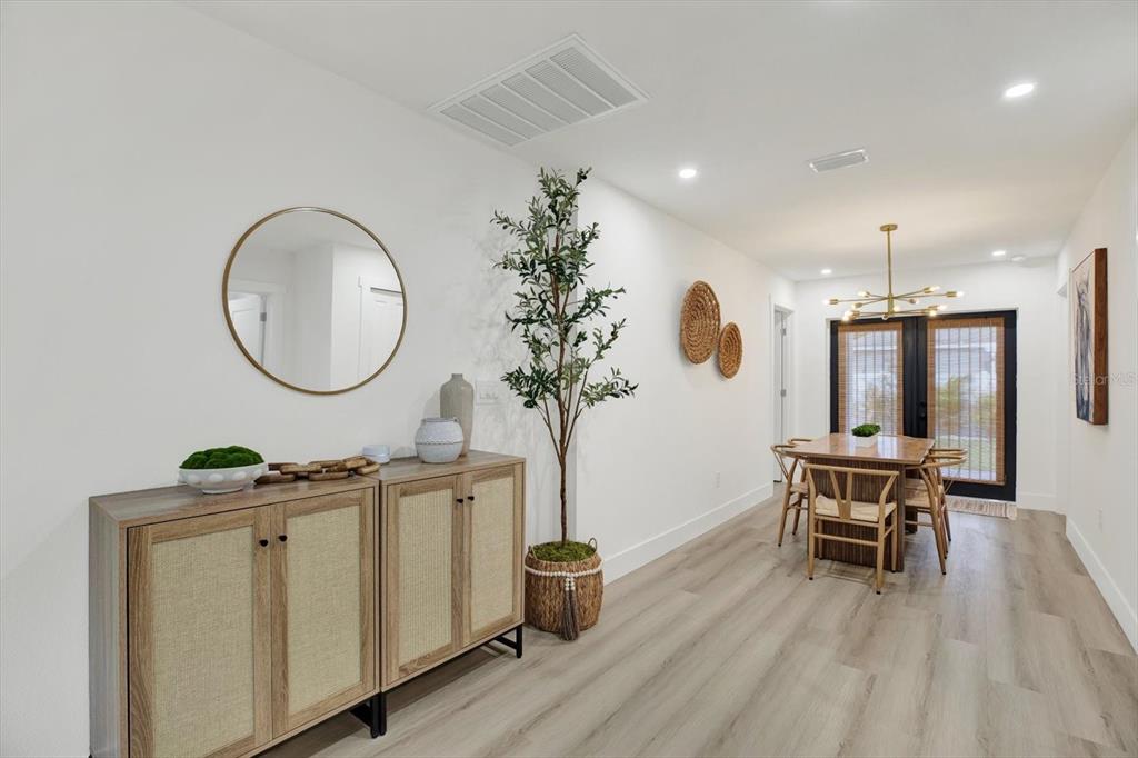 Undisclosed Address Tampa, FL 33607 - Photo 7 of 31 a living room with furniture a potted plant and a chandelier