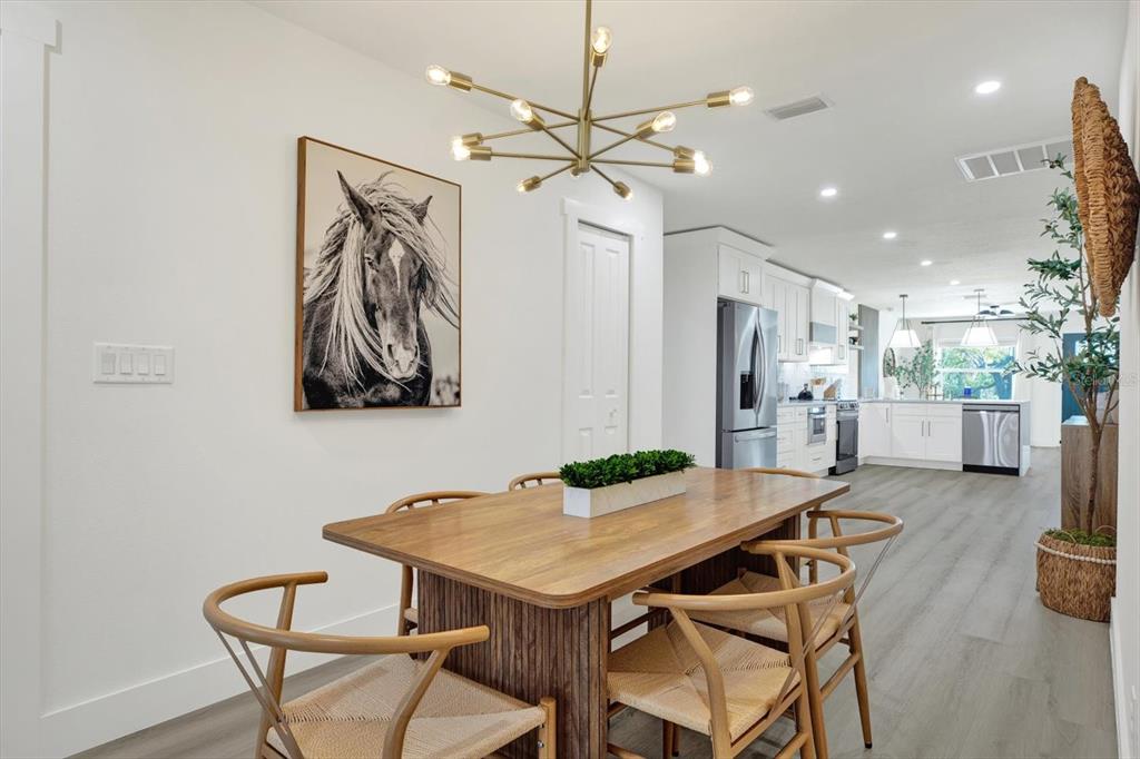 Undisclosed Address Tampa, FL 33607 - Photo 8 of 31 a view of a dining room with furniture and a chandelier