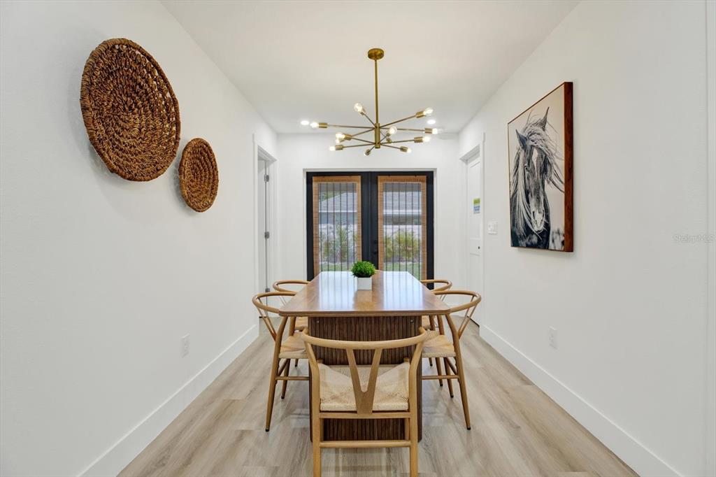 Undisclosed Address Tampa, FL 33607 - Photo 9 of 31 a view of a dining room with furniture and wooden floor