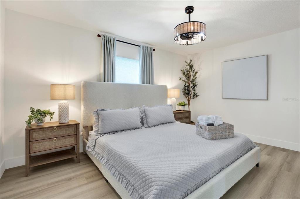 Undisclosed Address Tampa, FL 33607 - Photo 10 of 31 a bedroom with a bed and a chandelier