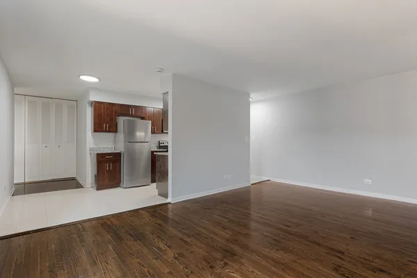 a view of a kitchen with a sink and a refrigerator