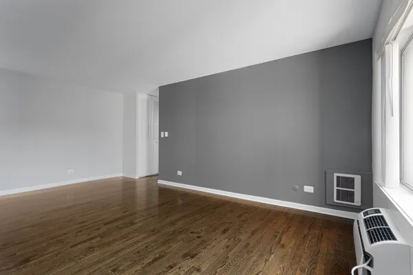 a view of a room with wooden floor