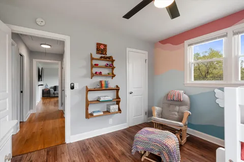 a bedroom with furniture and a flat screen tv