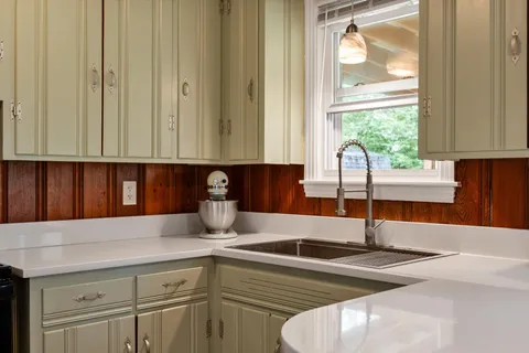 a kitchen with a stove a sink and a refrigerator