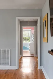 a white bath tub sitting next to a white sink and vanity