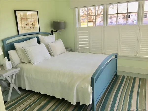 a bed sitting in a bedroom next to a window