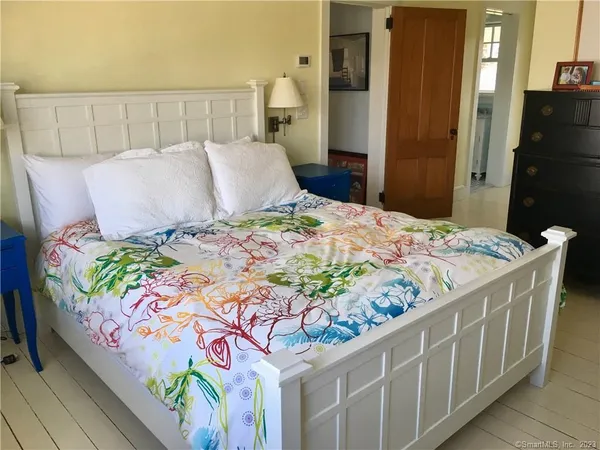 a bedroom with a bed and mirror