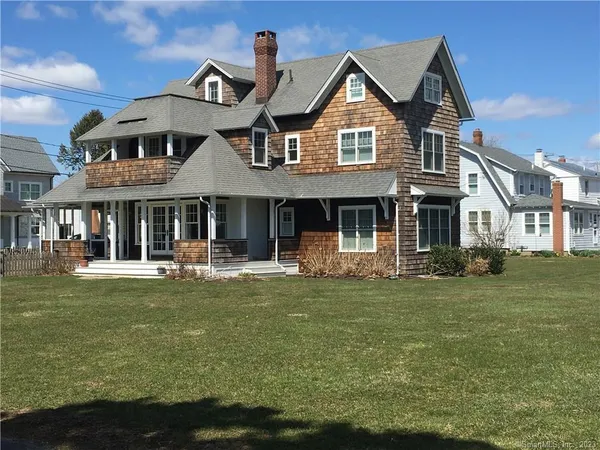a front view of a house with swimming pool having outdoor seating