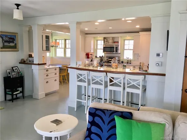 a kitchen with a table chairs stove and wooden floor