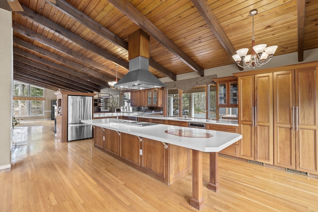 96 Deborah Road Hanover, MA 02339 - Photo 12 of 41 a kitchen with stainless steel appliances granite countertop a sink a counter space wooden floor and stainless steel appliances