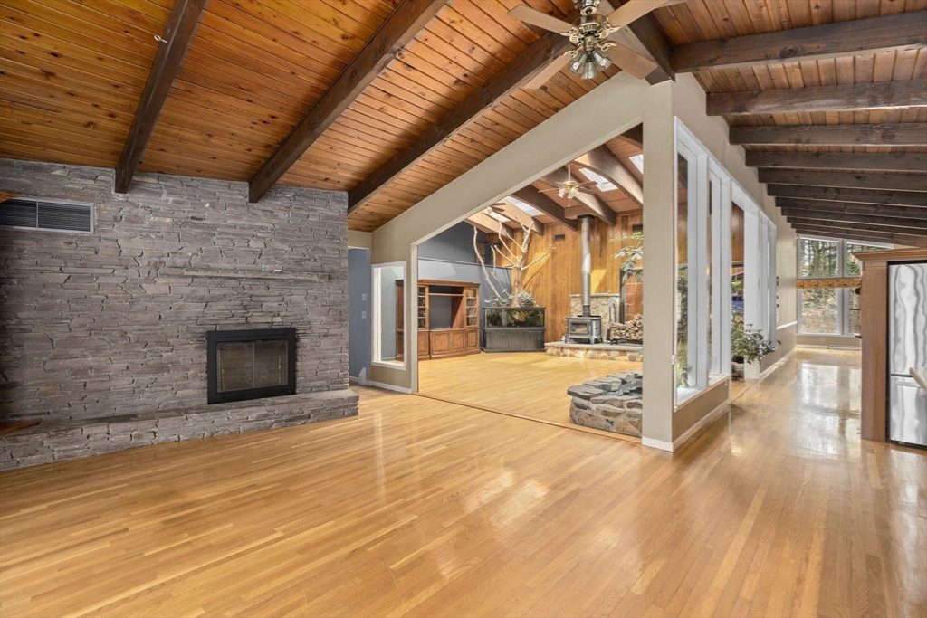 96 Deborah Road Hanover, MA 02339 - Photo 14 of 41 a view of an empty room with wooden floor and a fireplace