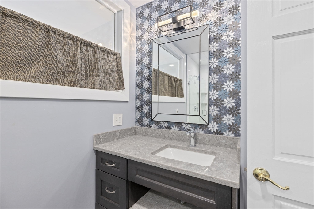 96 Deborah Road Hanover, MA 02339 - Photo 36 of 41 a bathroom with a granite countertop sink and a mirror