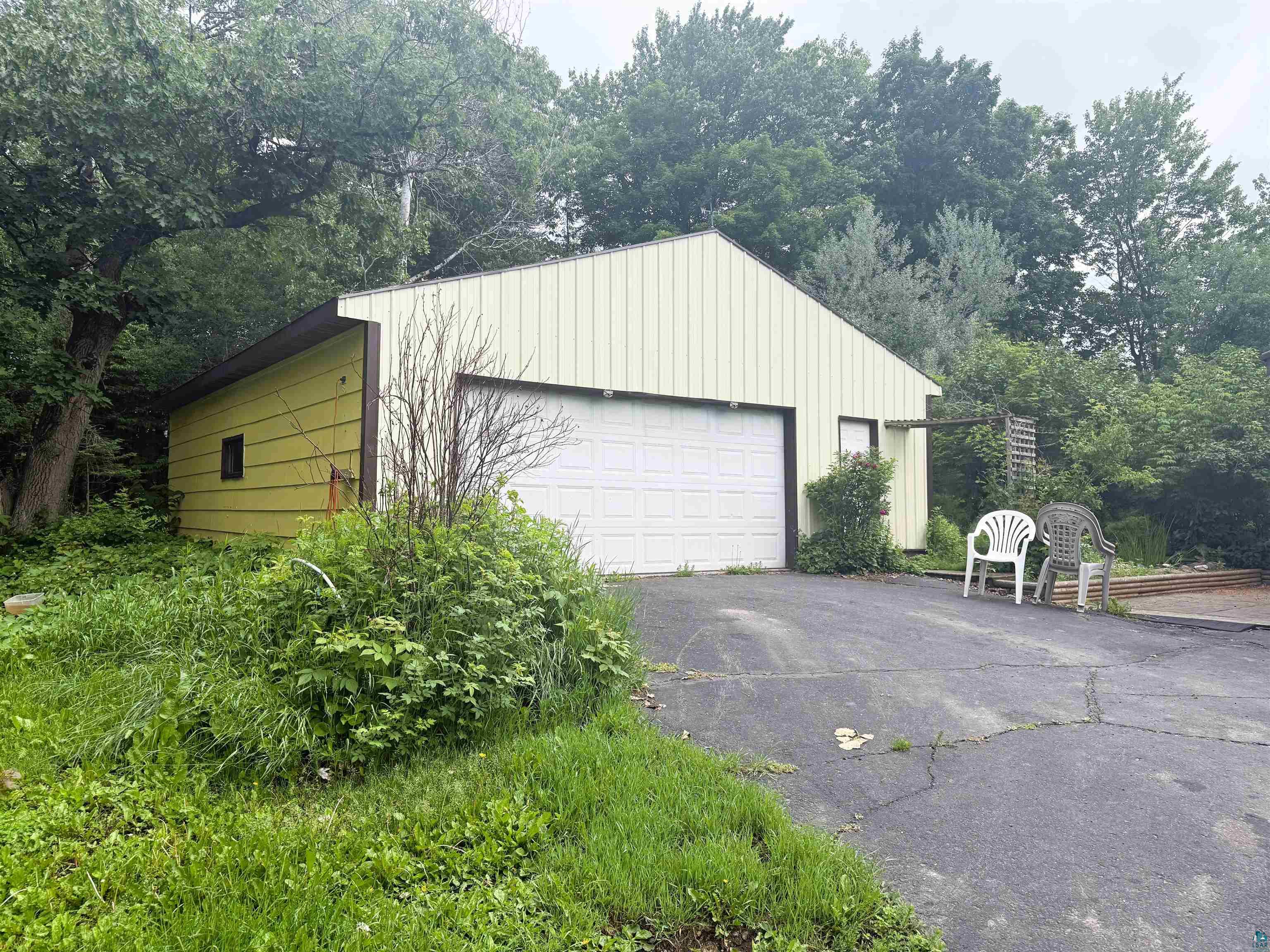 3541 Bent Trout Lake Road Barnum, MN 55707 - Photo 2 of 41 Detached garage structure featuring a single overhead door, an additional pedestrian entry, and vertical panel siding