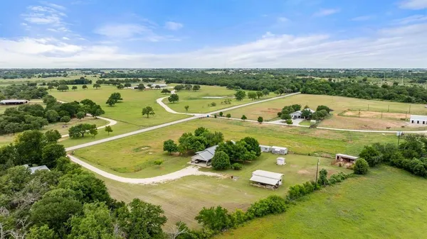 an aerial view of a house with a swimming pool