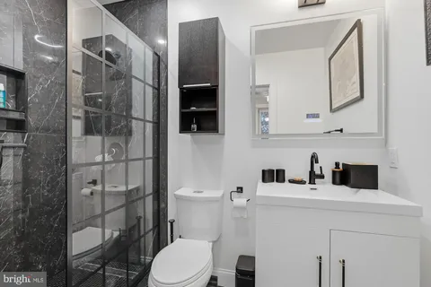 a bathroom with a sink toilet and shower