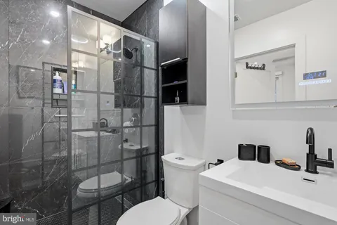 a bathroom with a toilet a sink and shower