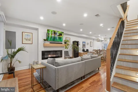 a living room with furniture a fireplace and a potted plant