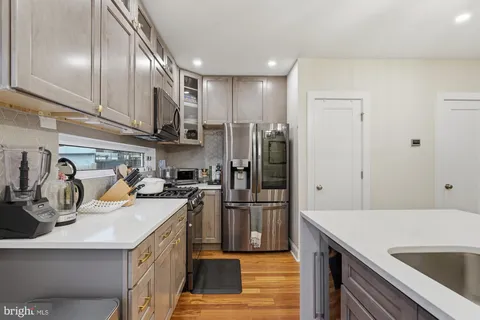 a kitchen with refrigerator and cabinets