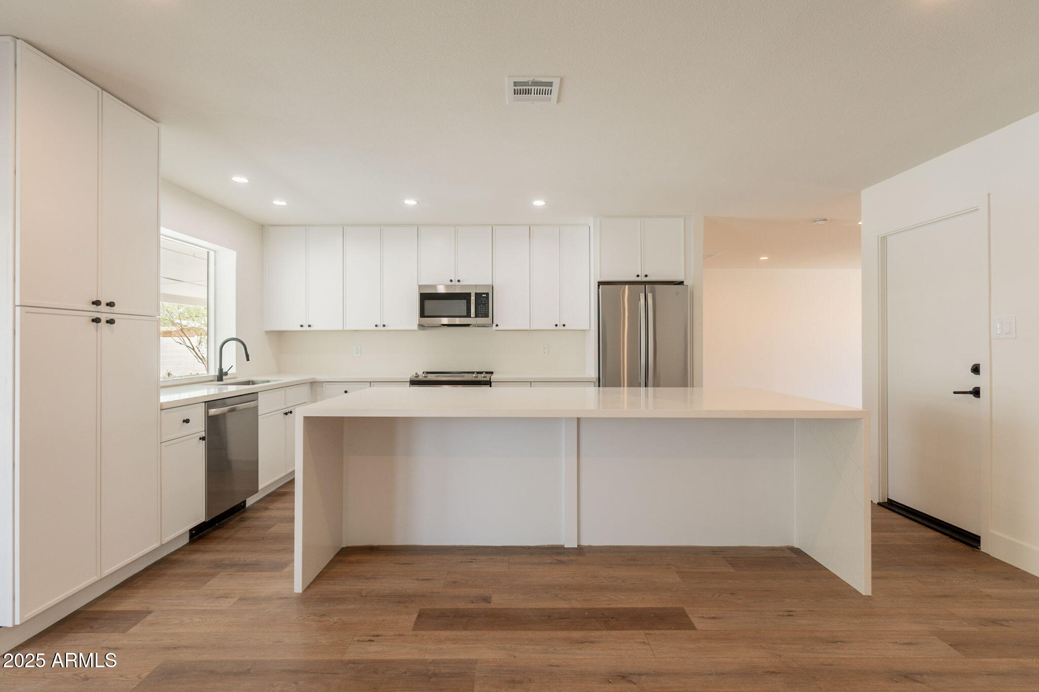 1530 East Alameda Drive Tempe, AZ 85282 - Photo 12 of 54 a kitchen with stainless steel appliances granite countertop a refrigerator sink and white cabinets