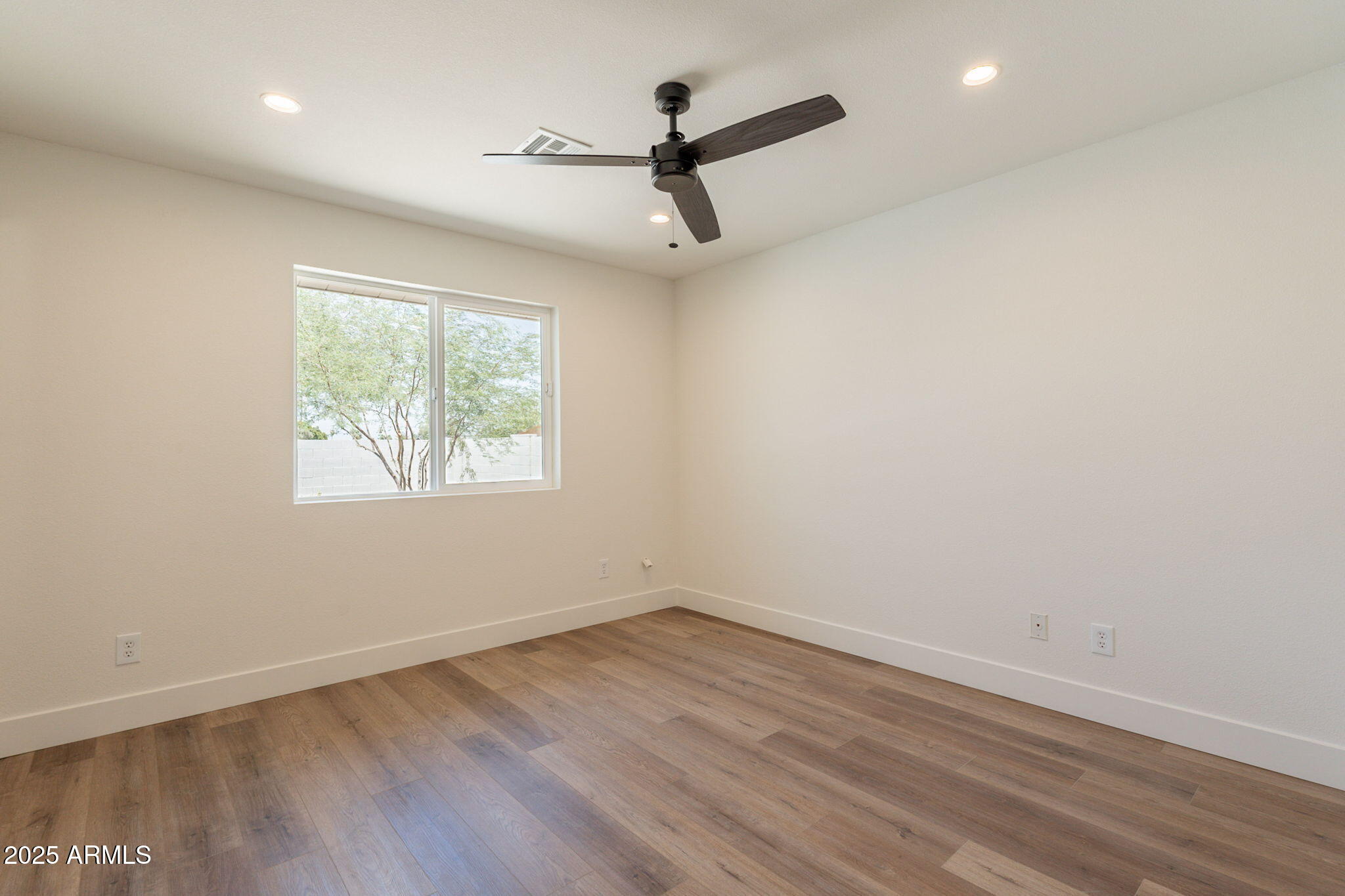 1530 East Alameda Drive Tempe, AZ 85282 - Photo 27 of 54 an empty room with wooden floor and windows