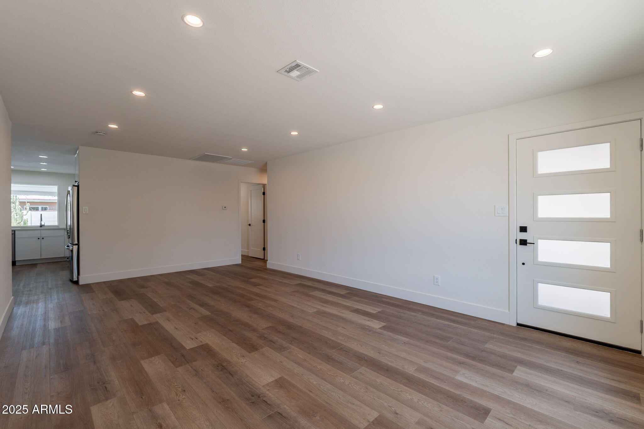 1530 East Alameda Drive Tempe, AZ 85282 - Photo 4 of 54 an empty room with wooden floor & closet area