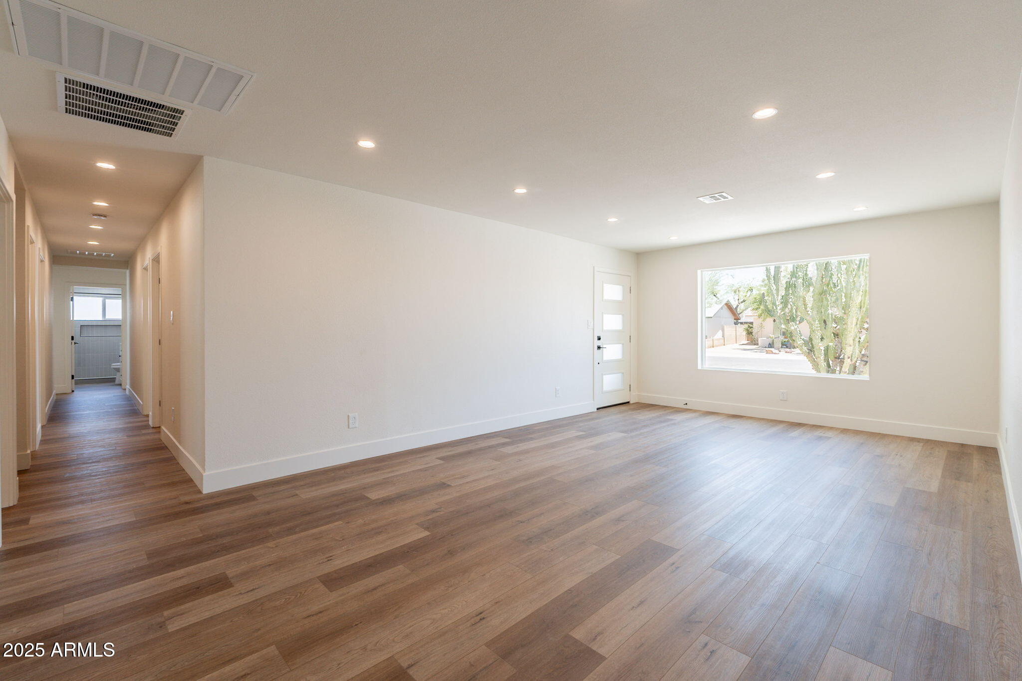 1530 East Alameda Drive Tempe, AZ 85282 - Photo 5 of 54 an empty room with wooden floor and windows