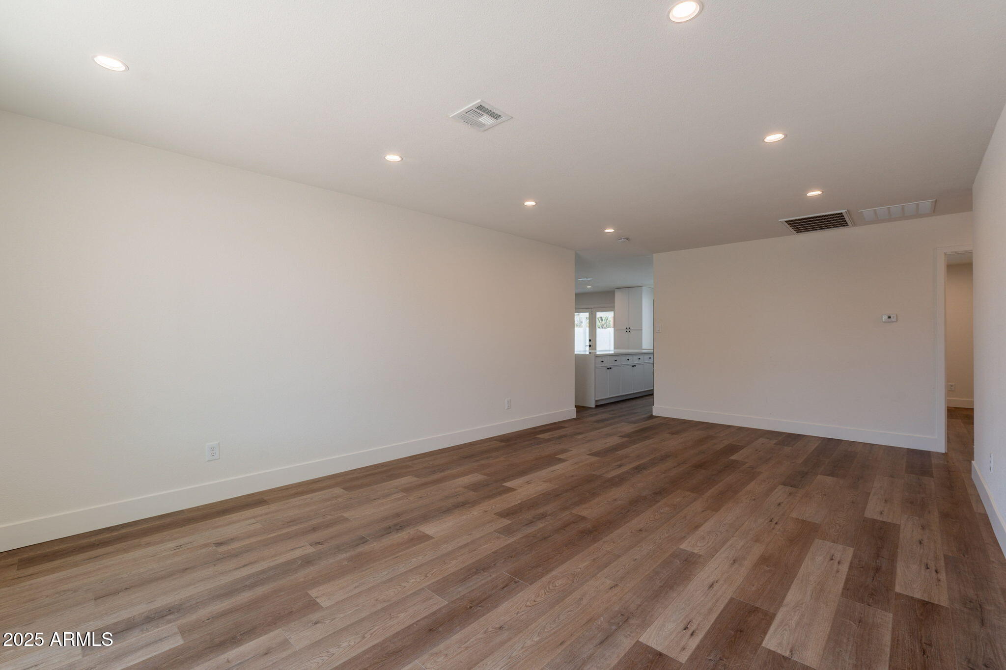 1530 East Alameda Drive Tempe, AZ 85282 - Photo 6 of 54 an empty room with wooden floor and windows