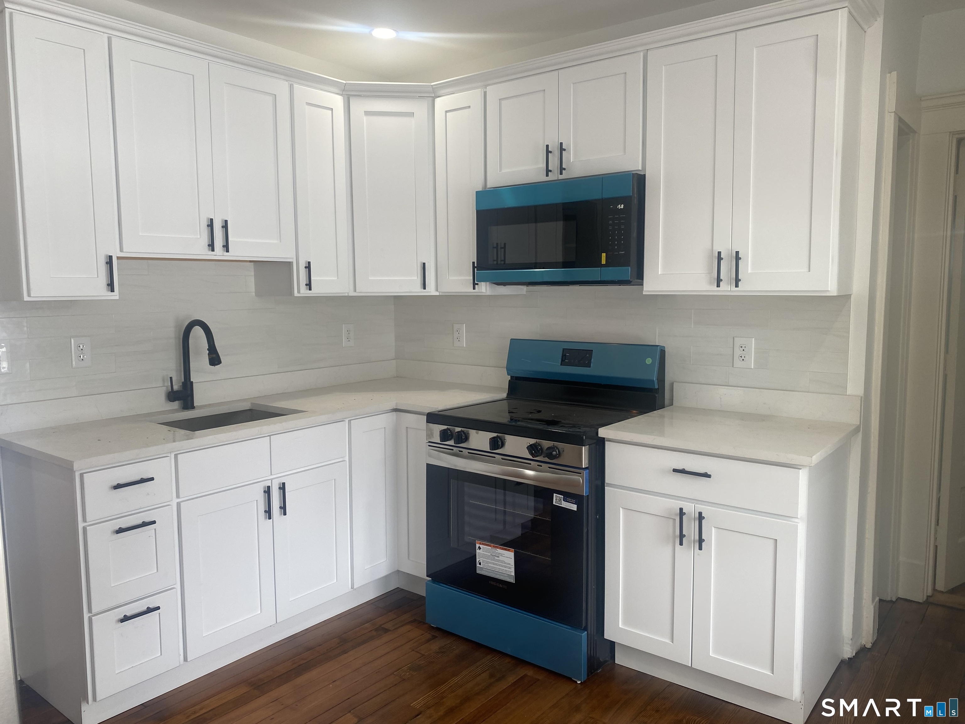 86 Foote Street Hamden, CT 06517 - Photo 14 of 14 a kitchen with white cabinets and stainless steel appliances