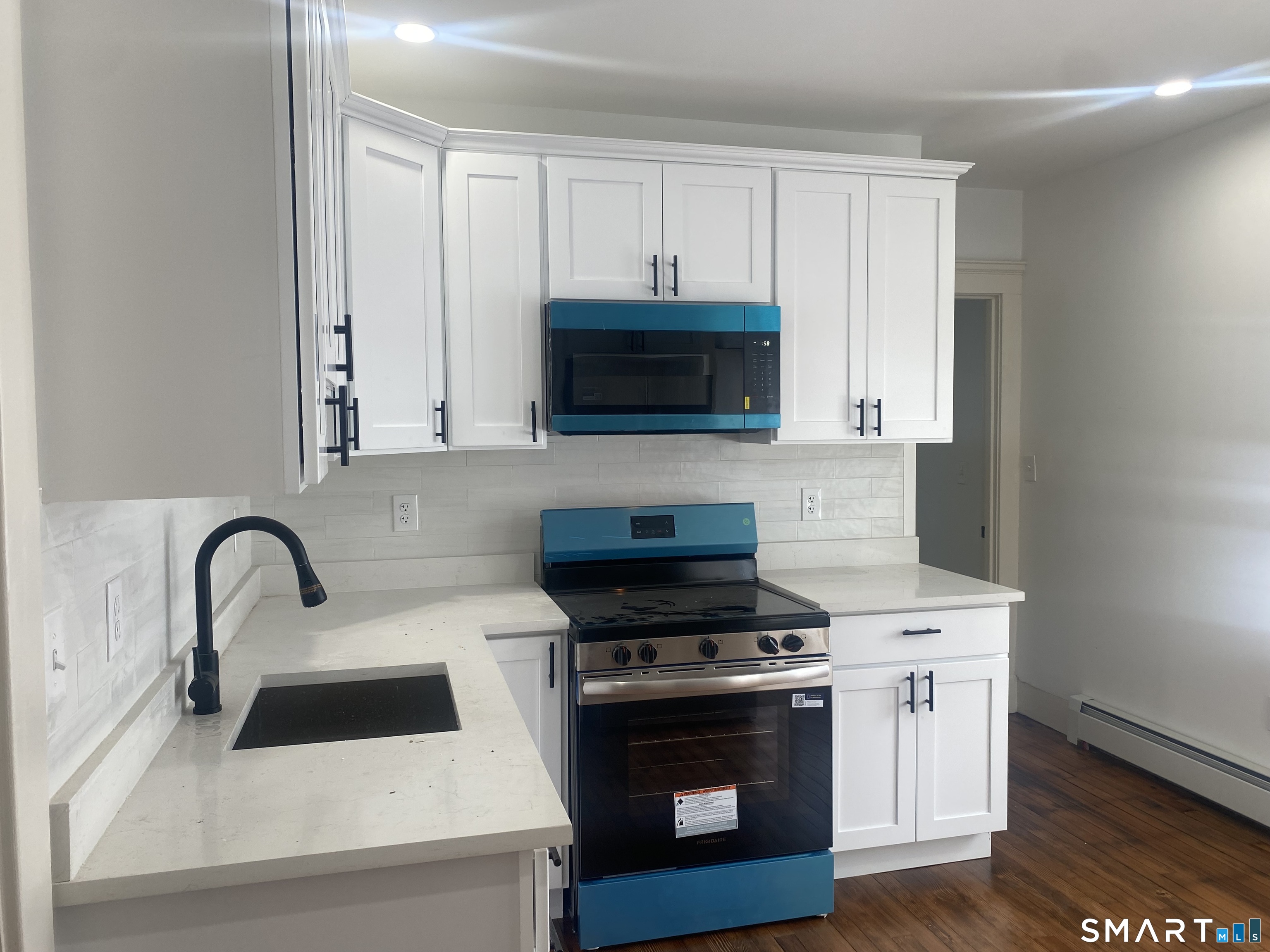 86 Foote Street Hamden, CT 06517 - Photo 4 of 14 a kitchen with a stove and a microwave