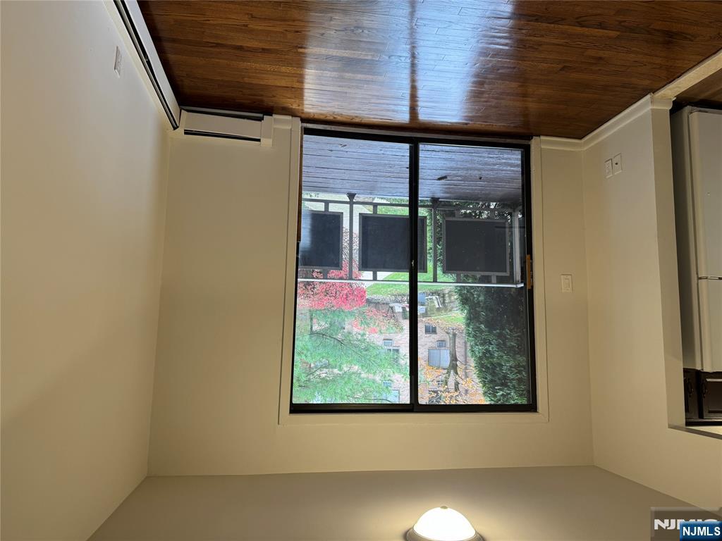 102 Bellgrove Drive, Unit 4A Mahwah, NJ 07430 - Photo 2 of 11 an empty room with wooden floor and windows