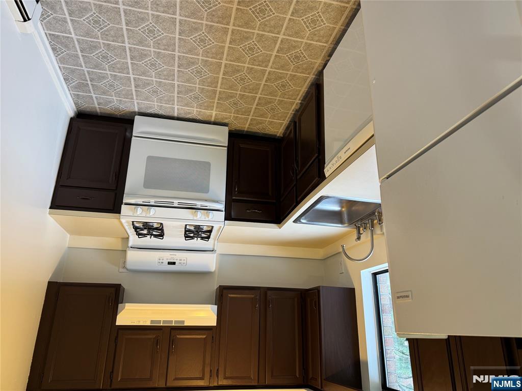 102 Bellgrove Drive, Unit 4A Mahwah, NJ 07430 - Photo 3 of 11 a kitchen with a sink stove and cabinets