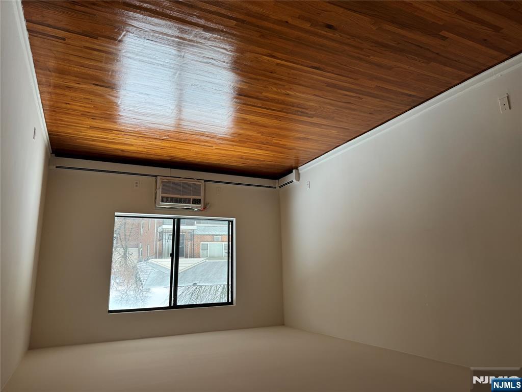 102 Bellgrove Drive, Unit 4A Mahwah, NJ 07430 - Photo 4 of 11 an empty room with wooden floor and windows