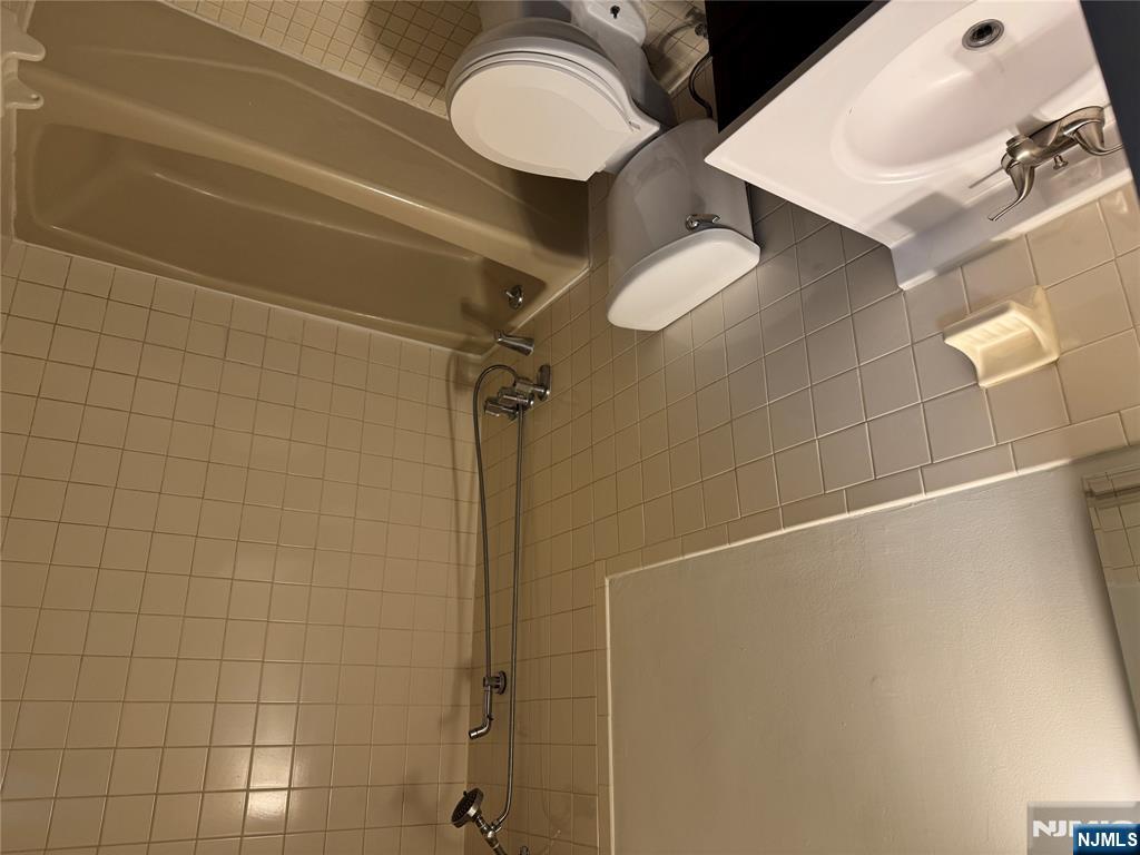 102 Bellgrove Drive, Unit 4A Mahwah, NJ 07430 - Photo 6 of 11 a bathroom with a sink a toilet and a bathtub