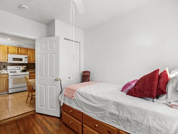 a bedroom with a bed and a stove