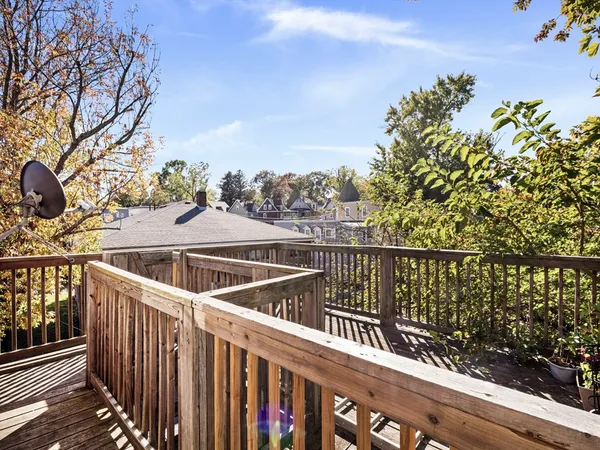 a view of a balcony with wooden floor and fence