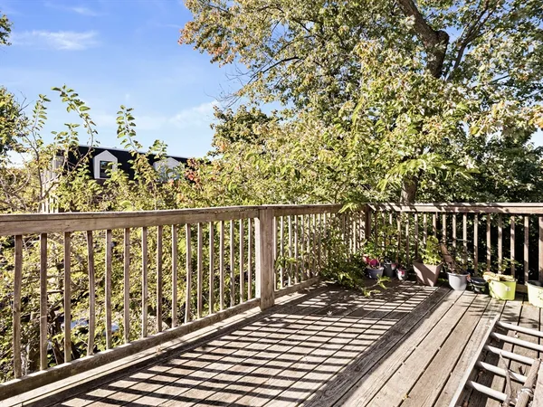 a balcony with wooden floor and outdoor space