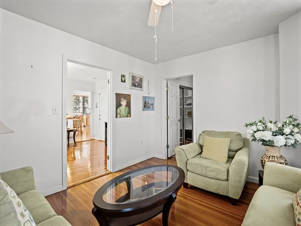 a living room with furniture and a wooden floor