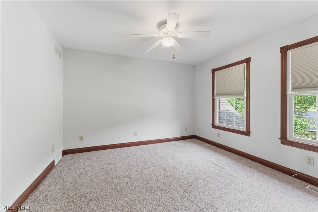 2184 Brenner Road Northeast Carrollton, OH 44615 - Photo 33 of 50 Spacious room with white walls, light-colored carpet, and dark wood-trimmed windows